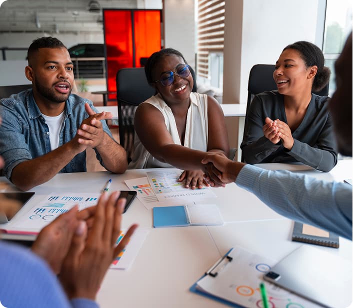 Team meeting celebrating growth